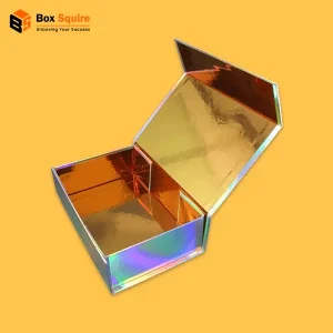 A stack of custom holographic magnetic closure boxes in rigid stock from Box Squire, showcasing a brilliant, shifting rainbow effect under studio lighting.