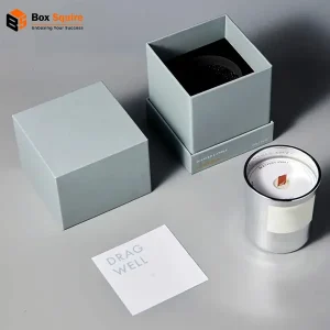 Custom printed candle three piece rigid box with a secure foam insert from Box Squire, holding three white pillar candles.