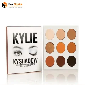 Custom printed eye shadow tuck boxes by Box Squire, showcasing a matte black finish and gold foil logo.